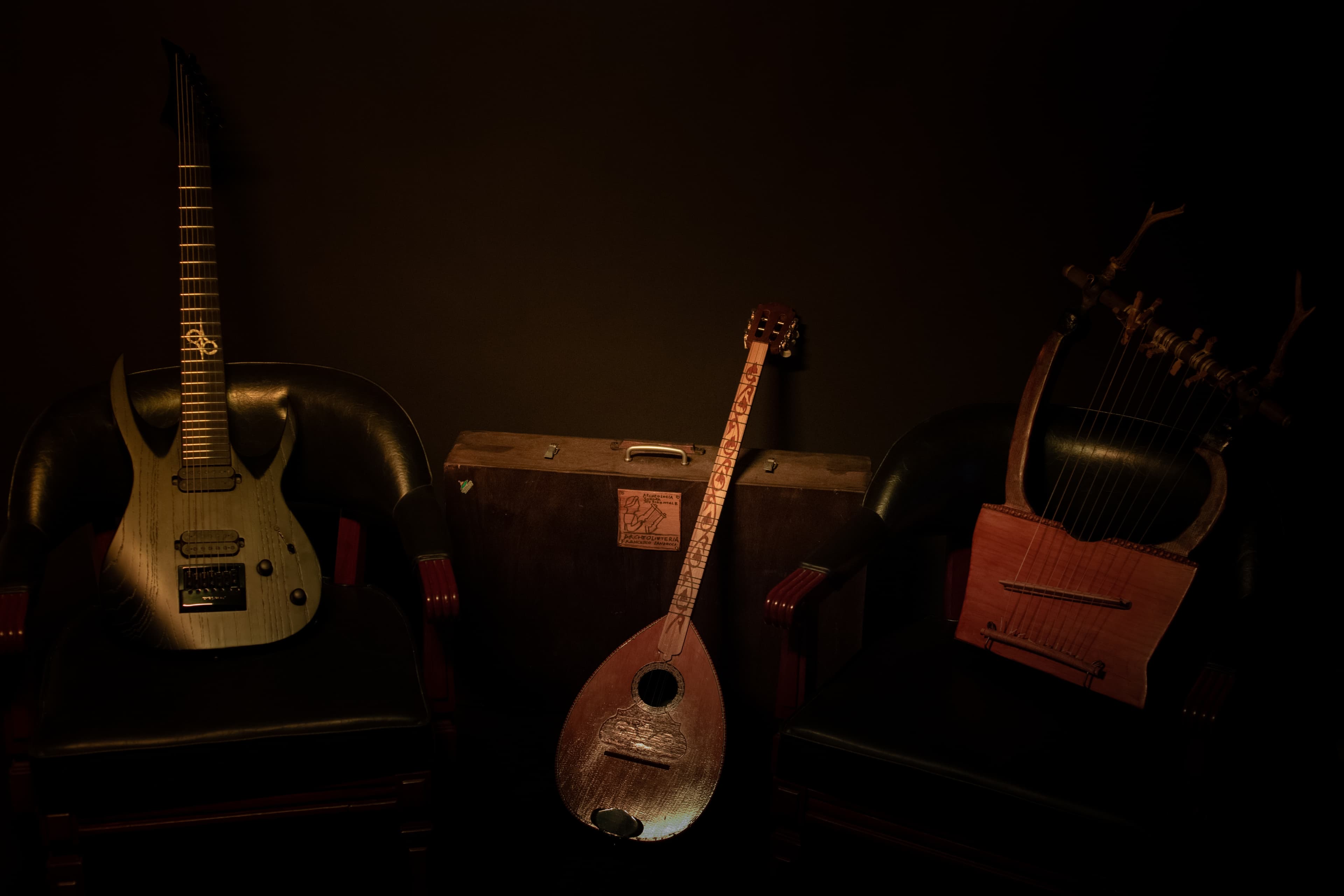 Electric guitar and traditional string instruments in warm light